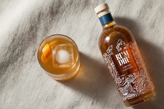 Rum Dhu Gold Rum bottle with Old Fashioned ingredients on linen