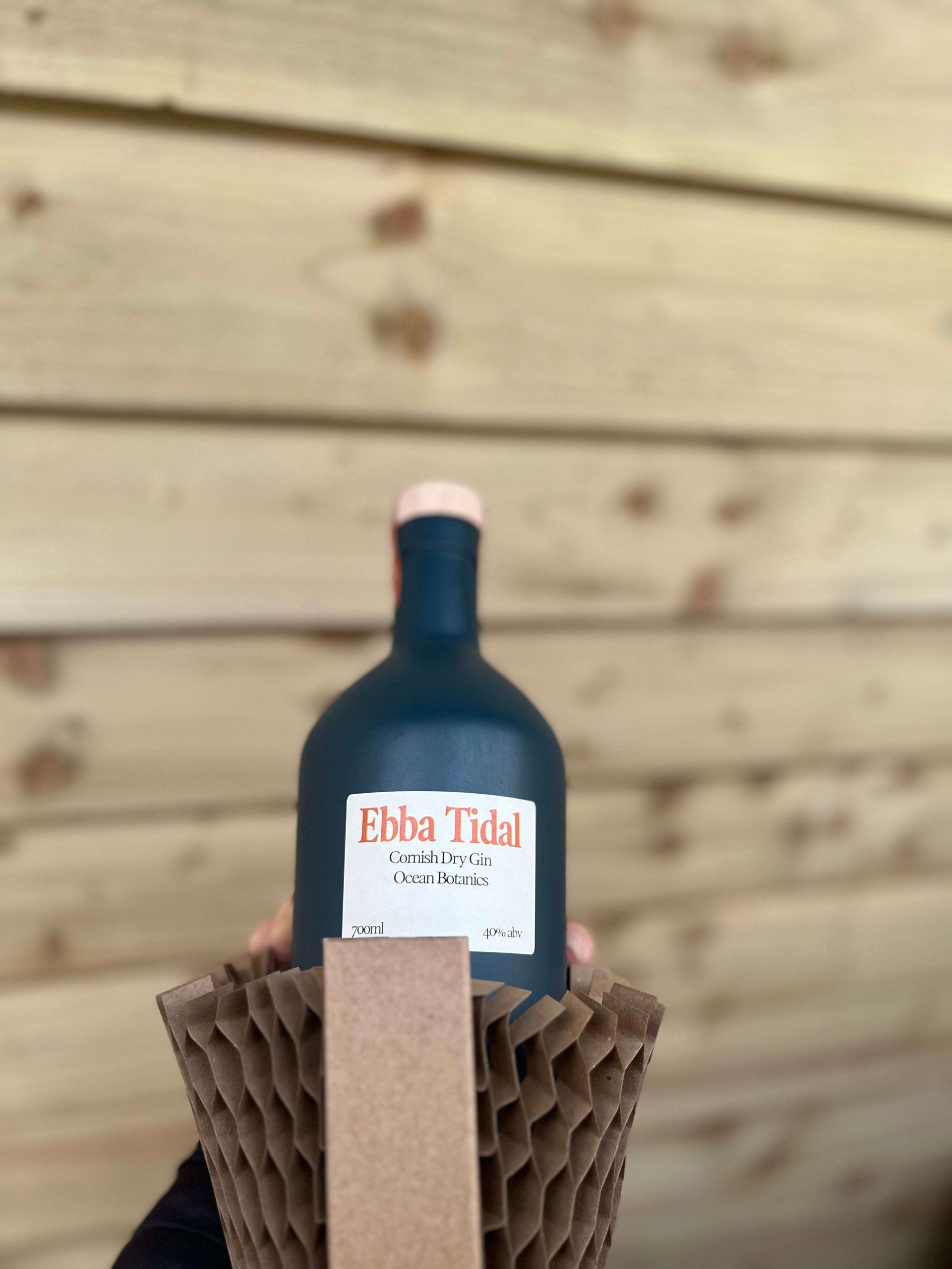 Dark teal bottle of Ebba tidal Cornish dry gin in a Flexi hex sleeve
