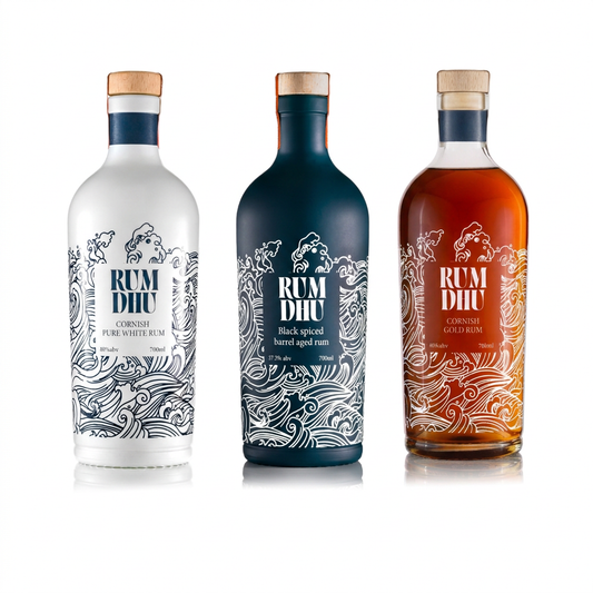Rum Dhu Pure White, Black Spiced and Cask Aged Gold rum bottles together on a white background